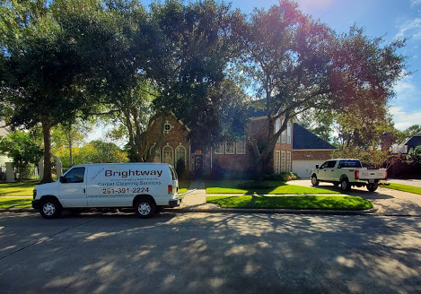 A white truck parked in front of a house.